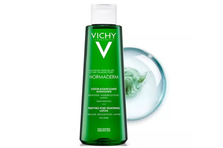Chai lotion màu xanh lá cây với nhãn hiệu nổi bật, đặt cạnh hình ảnh minh họa dạng giọt chất lỏng.