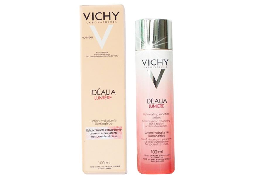 Chai và hộp kem dưỡng ẩm Vichy Idéalia Lumière 100ml, thiết kế màu hồng và trắng.