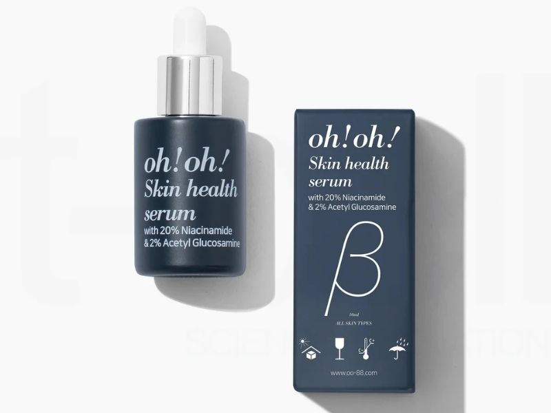 0d001153-serum-lam-deu-mau-da-7 Chai serum dưỡng da màu xanh đậm với hộp giấy, có chữ "oh! oh! Skin health serum" màu trắng.