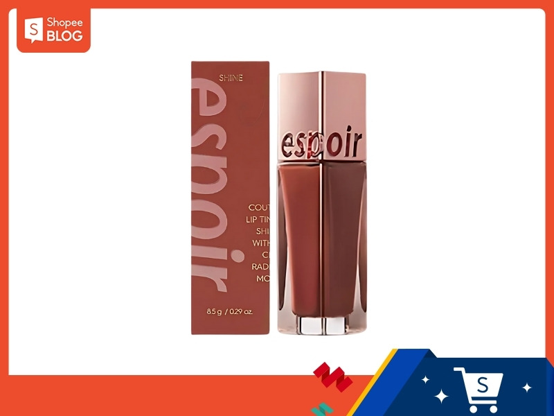 181b6ec3-review-son-espoir-6 Son bóng màu nâu đỏ với hộp đựng có chữ, thiết kế sang trọng, nền trắng, khung viền cam.