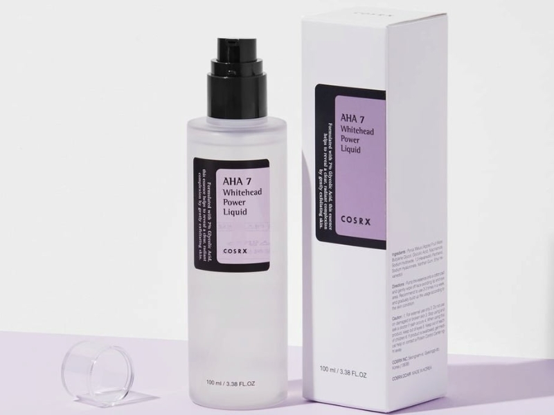 20dda958-ah Chai và hộp sản phẩm chăm sóc da AHA 7 Whitehead Power Liquid, dung tích 100 ml, nắp đen và nhãn tím.