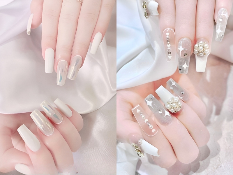Bàn tay với móng tay dài, thiết kế nghệ thuật màu trắng và ánh kim, trang trí ngọc trai và họa tiết lấp lánh.