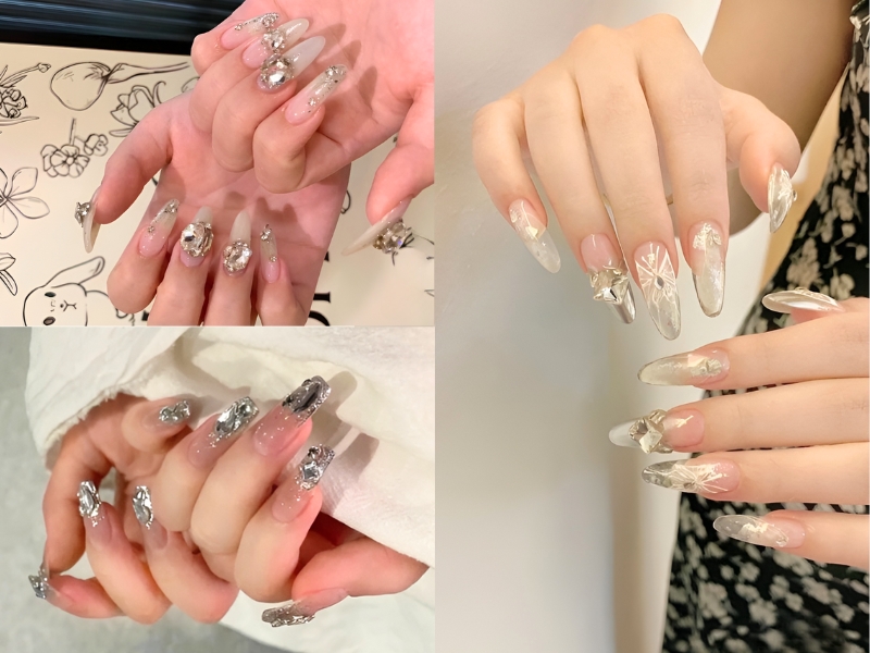 Bộ móng tay dài được trang trí với hoa văn và đá lấp lánh, thể hiện sự sáng tạo và phong cách.