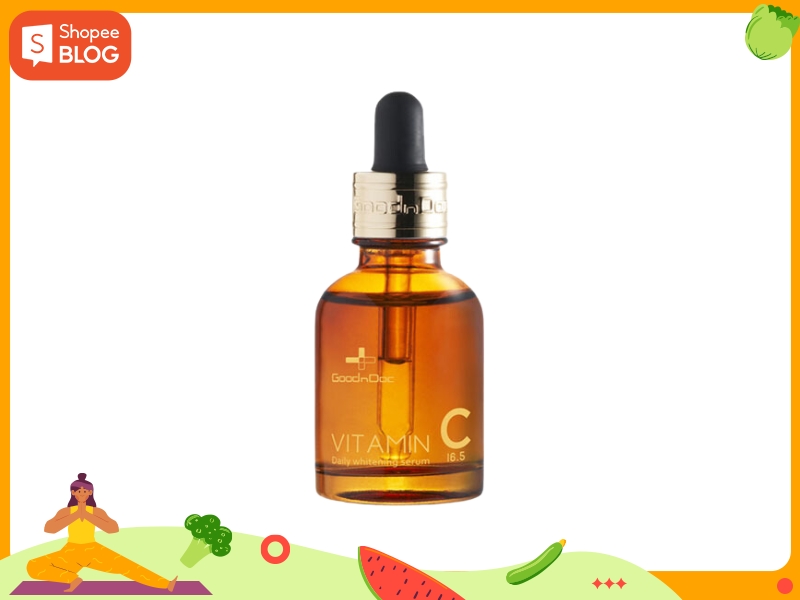 7677ff8d-serum-cho-da-hon-hop-thien-dau-5 Chai serum vitamin C màu hổ phách với nắp đen và viền vàng, nền trắng, khung viền cam.