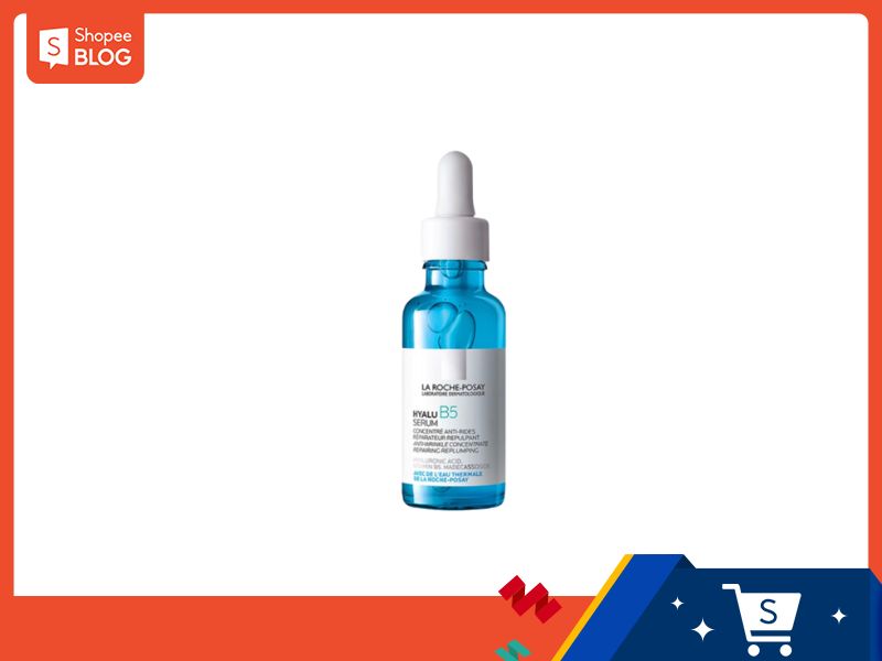 c75b86cb-serum-tai-tao-da-5 Chai serum màu xanh dương với ống nhỏ giọt, nền trắng, viền cam, biểu tượng mua sắm ở góc dưới.