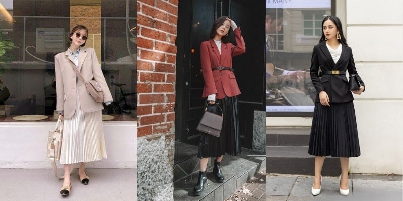 Ba người mặc áo blazer và chân váy xếp ly, đứng tạo dáng bên ngoài tòa nhà.