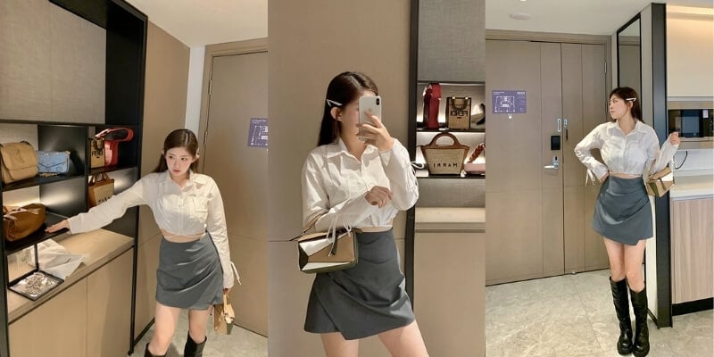 Người mặc áo sơ mi trắng, váy xám đứng trước kệ với nhiều túi xách, chụp ảnh tự sướng bằng điện thoại.