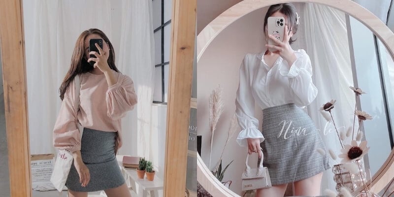 Người chụp ảnh trước gương, mặc áo sơ mi và váy, trang trí phòng với cây xanh và hoa.