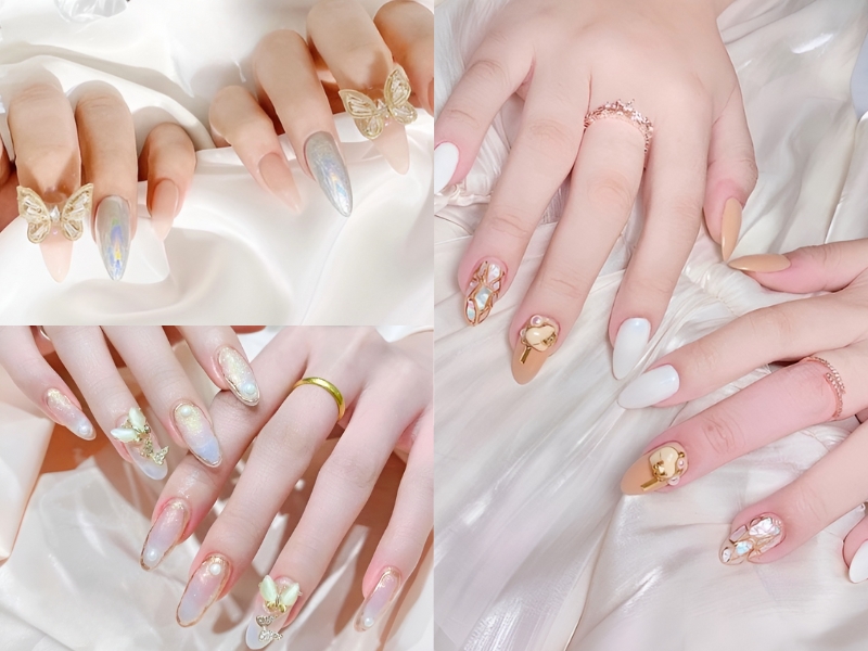 Bộ móng tay được trang trí với họa tiết bướm, ngọc trai và màu sắc ánh kim trên nền vải trắng.