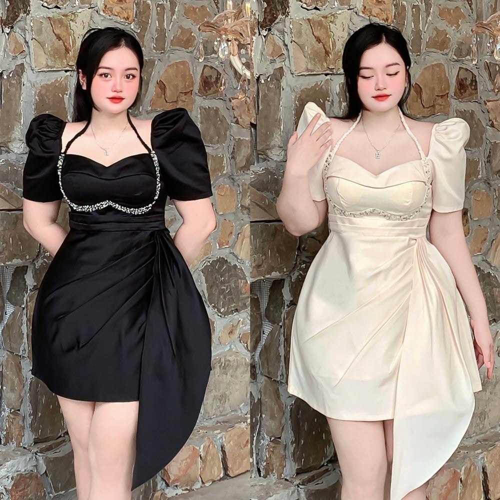 Người mẫu trong hai chiếc váy màu đen và trắng, đứng trước bức tường đá, trang phục có chi tiết đính cườm.