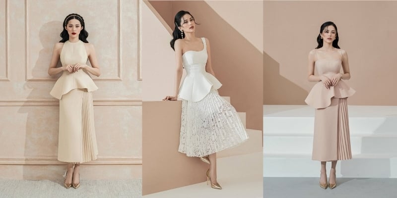Ba người mẫu mặc váy với thiết kế peplum, đứng tạo dáng trước nền tường màu trung tính.