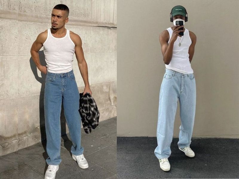 Hai người mặc áo ba lỗ trắng và quần jeans xanh đứng trước tường, một người cầm áo kẻ, người kia đeo tai nghe.