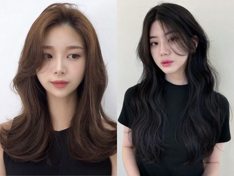 Hai người với kiểu tóc dài, một người tóc nâu và một người tóc đen, cùng mặc áo đen.