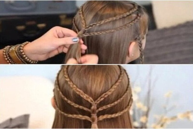 Người đang tạo kiểu tóc tết cho một người khác, với các bím tóc được xếp tầng trên đầu.