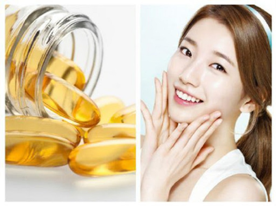 Hình ảnh viên nang màu vàng và người phụ nữ cười, chạm tay vào mặt, nền trắng.